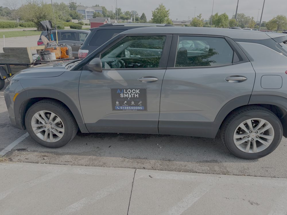 The AJ Locksmith branded service vehicle parked at a job