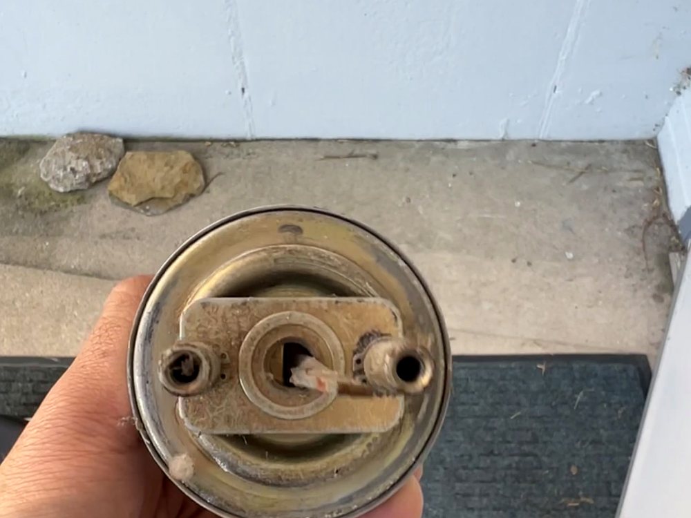 A residential knob lock stripped down to the cylinder during a rekey